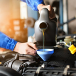 mechanic pouring oil